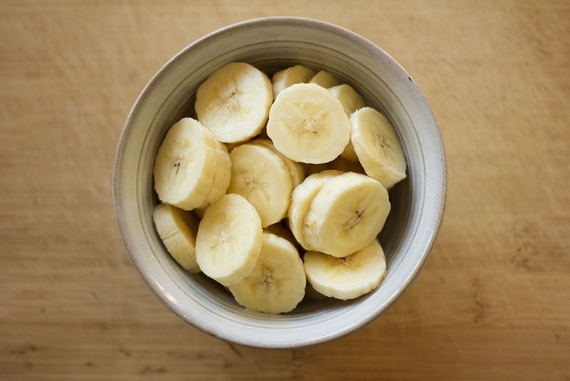 sliced bananas in a ceramic bowl