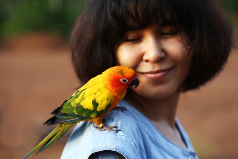 woman with her pet conure