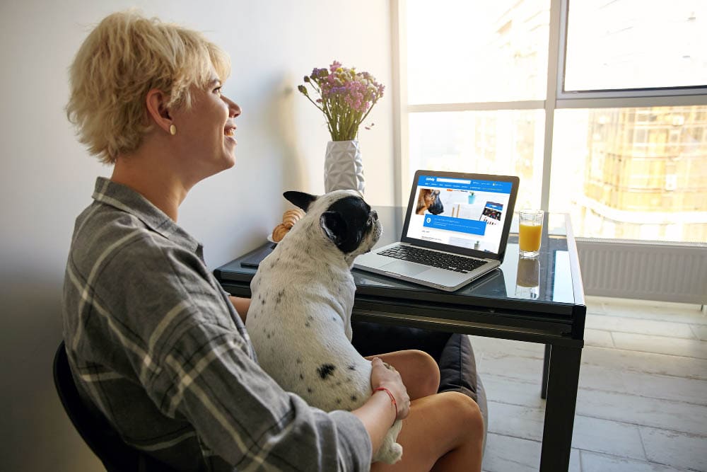 woman with dog checking out Chewy Affiliate Program