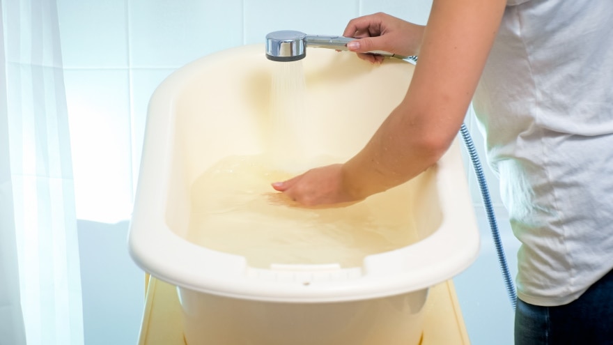 puring water in plastic bath tub