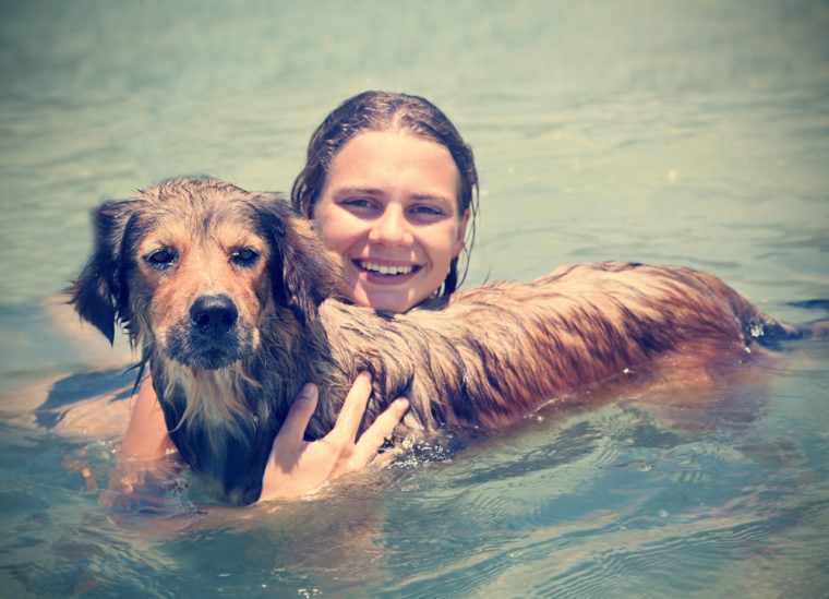 woman-swimming-with-her-dog
