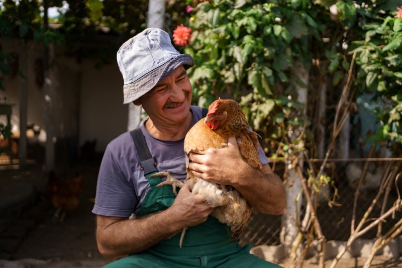 man holding chicken