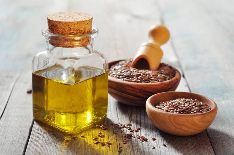 flaxseed oil and flaxseeds in a bowl