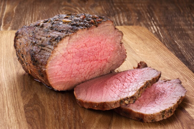 Roast beef on a wooden background