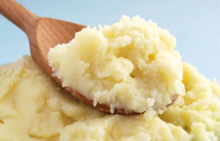 brown wooden spoon scooping mashed potato