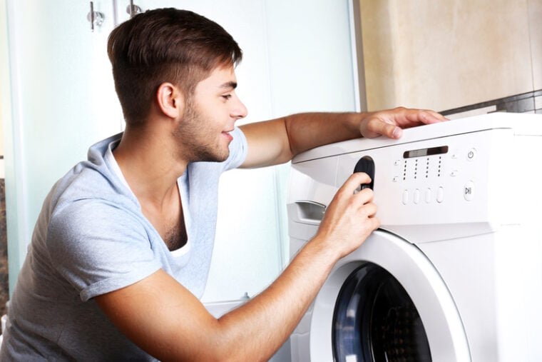 man using washing machine