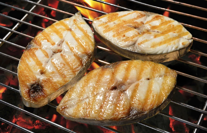 mackerel cooking on the grill