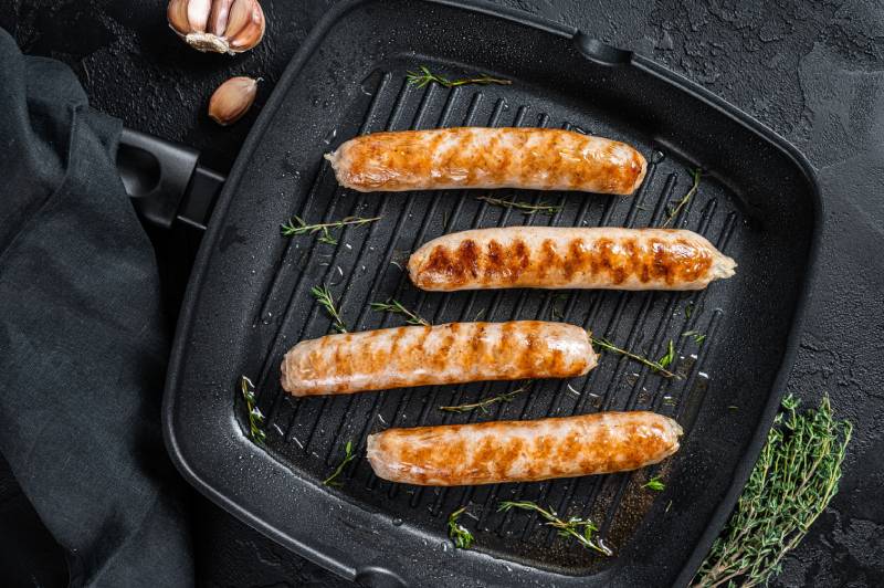 German grilled Bratwurst sausages in a grill pan