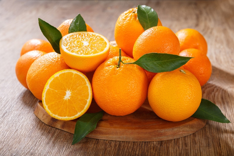 fresh orange fruits on wooden table