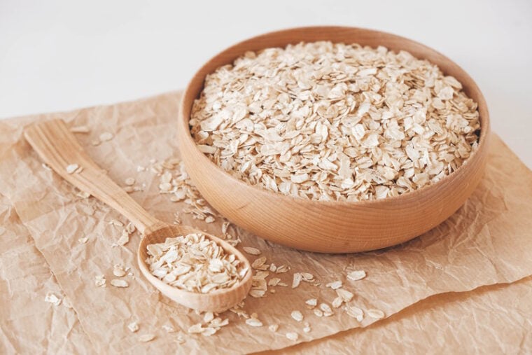 dry oatmeal in wooden bowl
