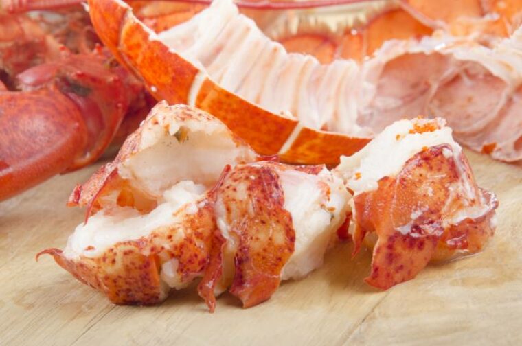 lobster meat and shell on wooden board