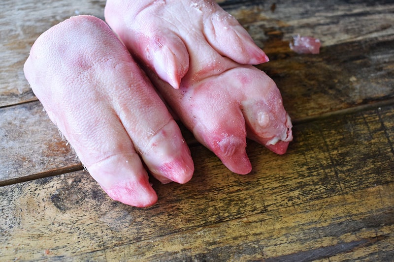 Fresh pork feet on an old wooden floor