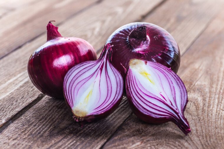 red onions on wooden table