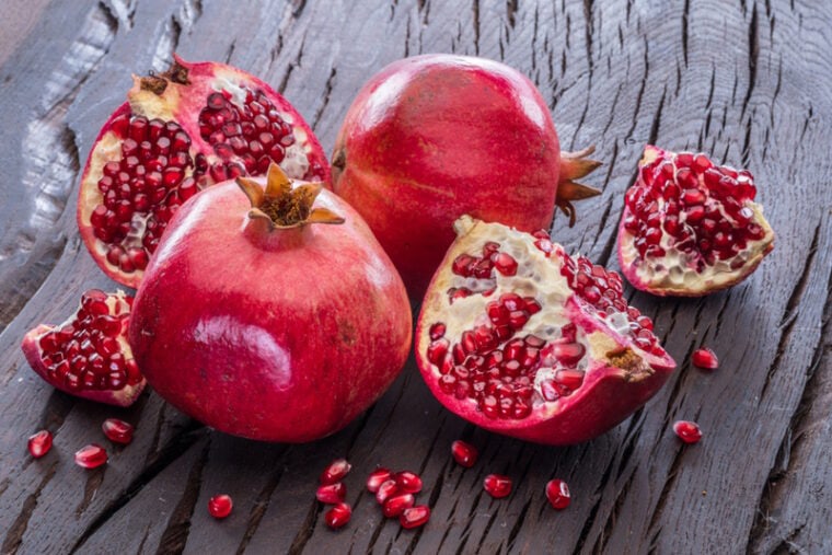 ripe pomegranate fruits on wooden background